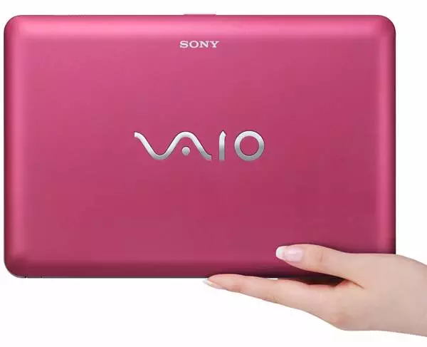A person holding up a pink Sony laptop starting at $999.99.