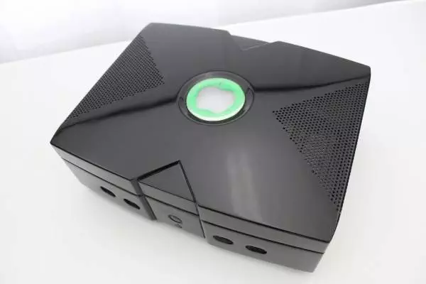 A black box with a green light on it, perfect for the Xbox Pro.