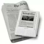The Kindle, an e-reader, is sitting on top of a newspaper.